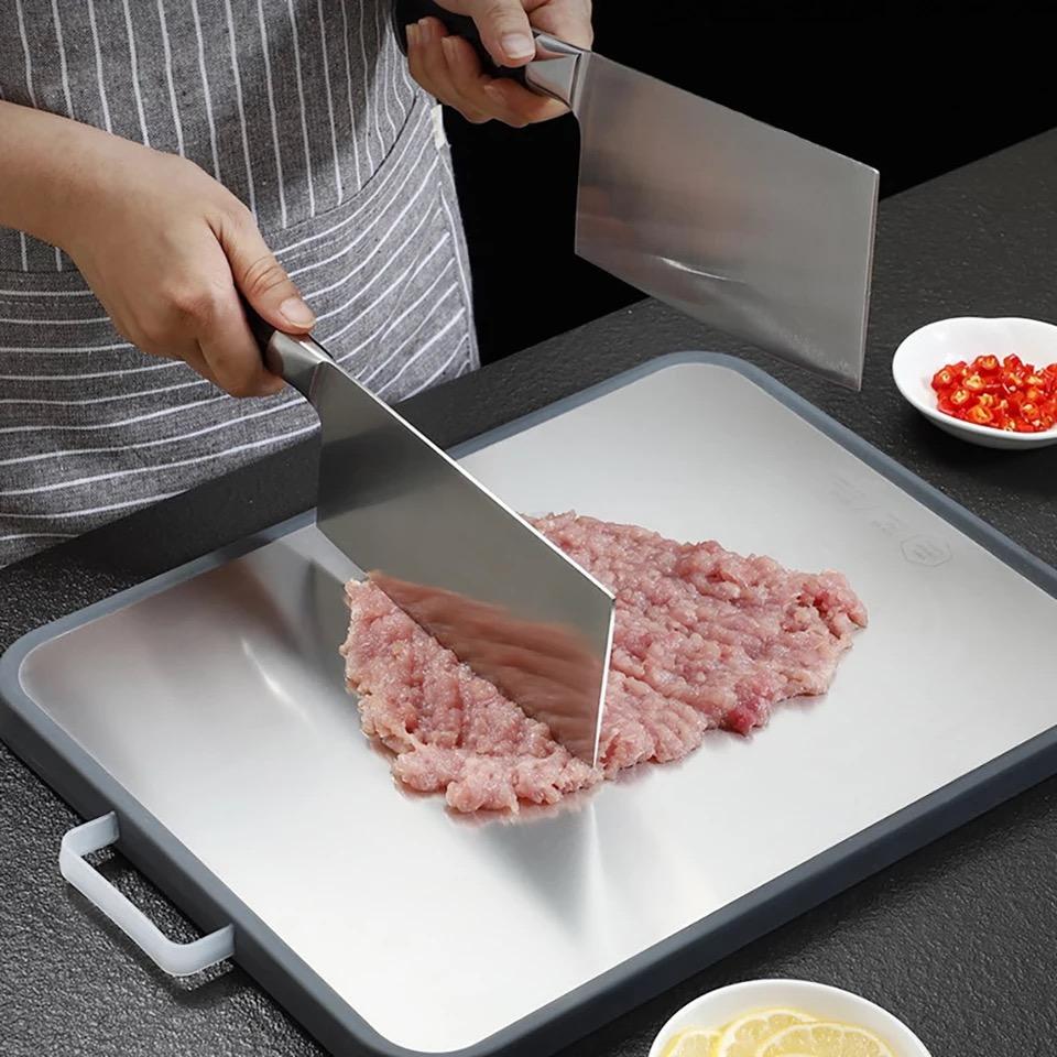 https://needs-store.com/cdn/shop/products/double-sided-stainless-steel-cutting-board-for-kitchen-juice-grooves-with-easy-grip-handles-plastic-chopping-board-for-kitchen-695268_960x.jpg?v=1639142901